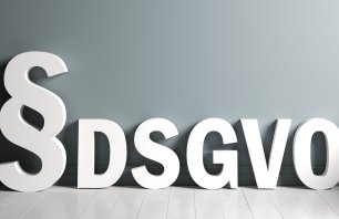 3D rendering of a paragraph symbol and the abbreviation "DSGVO" standing for the German words for "General Data Protection Regulation" in an empty room